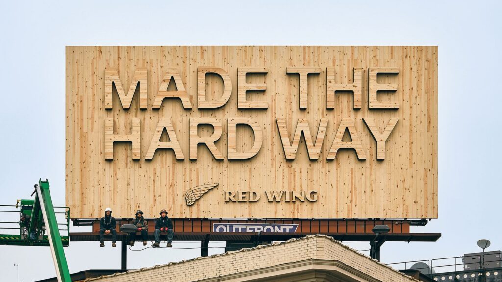 billboard that says "Made the Hard Way" fully made with wood
